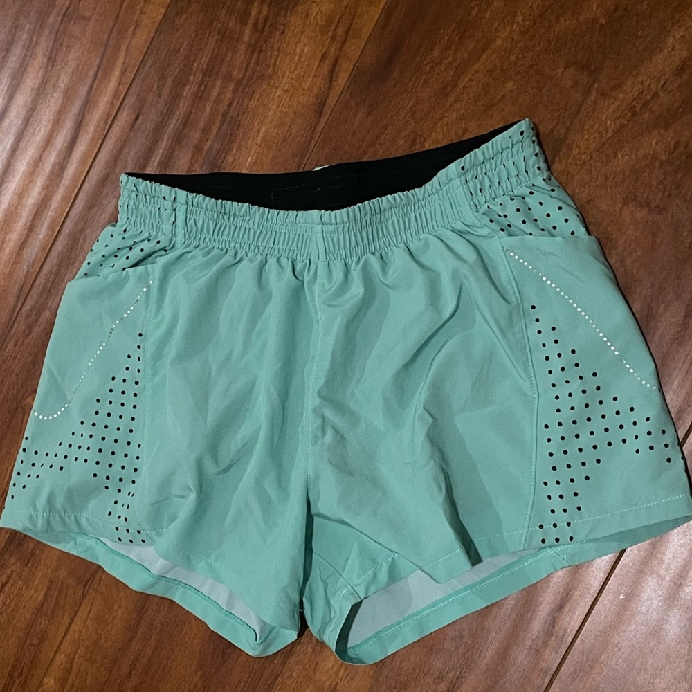 Green Senita athletics running shorts.